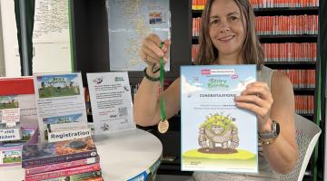 Hayley Coles with Summer Reading Challenge rewards August 2025