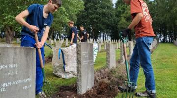 Teenagers tending the graves August 2025