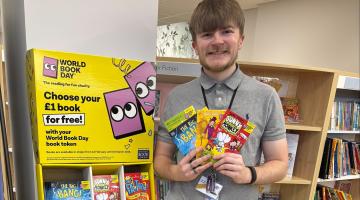 Library assistant at Burton Library with World Book Day display