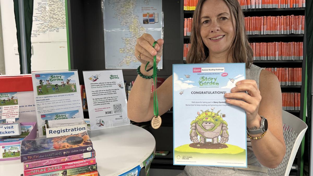 Hayley Coles with Summer Reading Challenge rewards August 2025
